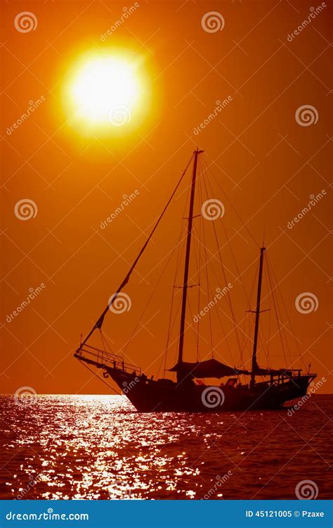 Silhouette Of Sailing Yacht In The Tropical Sea At Sunset Stock Image