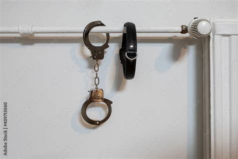 Handcuffs On The Radiator Police Handcuffs And Collar Stock Photo