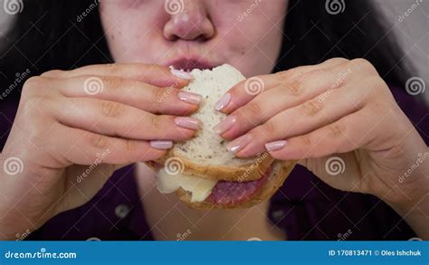 Extreme Close Up Of Obese Caucasian Brunette Woman Chewing Sandwich