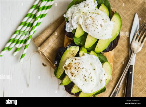 Healthy Sandwich With Avocado And Poached Eggs Stock Photo Alamy