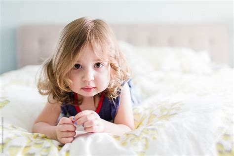 Young Toddler Girl Playing On A Bed By Stocksy Contributor Jakob