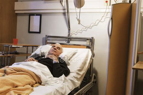 Senior Man Lying On Hospital Bed — Male Patient Stock Photo 307034016