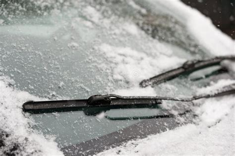 Car Wiper Blades Clean Snow From Car Windows Flakes Of Snow Covered