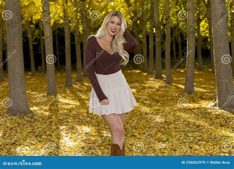 A Lovely Blonde Model Poses Outdoor While Enjoying The Fall Weather