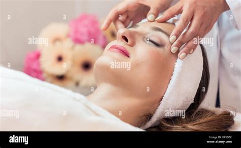 Beautiful Woman Relaxing During Rejuvenating Facial Massage In A Stock