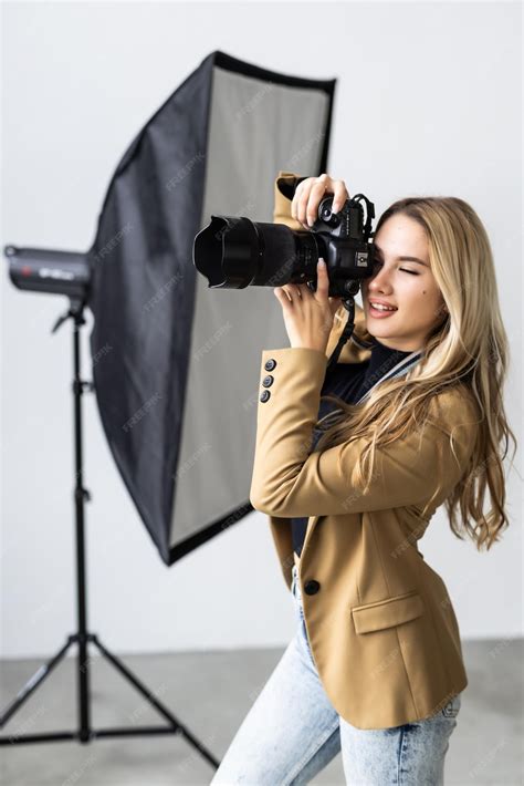 Premium Photo Young Female Photographer Posing In The Photo Studio
