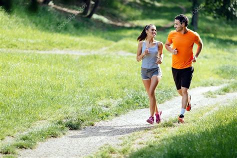 Beautiful Couple Jogging In Nature — Stock Photo © Nd3000