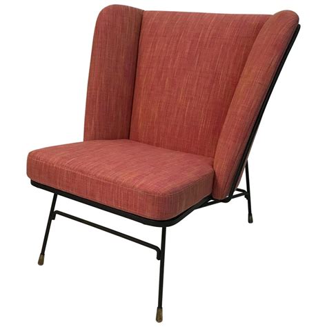 Or you can also get plain colored antique wingback chairs that would bring in a classic touch to your home. Mid-Century Modern Wrought Iron Upholstered Wingback Chair ...
