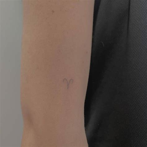 Minimalist Aries Zodiac Symbol Tattoo On The Upper Arm