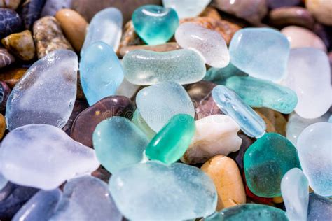 Natural Polish Textured Sea Glass And Stones On The Seashore Azure Clear Sea Water With Waves