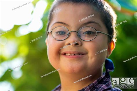 Portrait Of 7 Year Old Boy With Downs Syndrome Smiling At Camera Stock