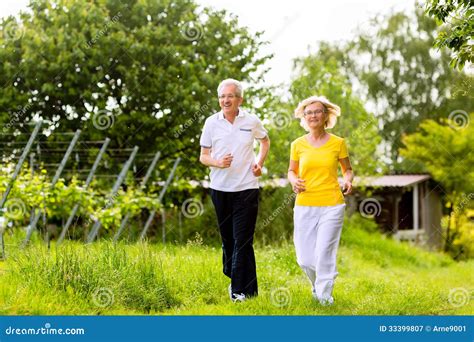 Seniors Running In The Nature Doing Sport Royalty Free Stock