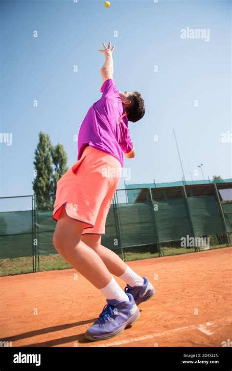 Young Tennis Player Serving The Ball Stock Photo Alamy