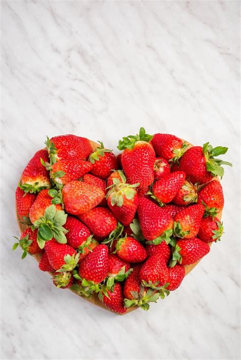 Heart Shape Strawberries On White Marble Love For Fresh Fruits Stock