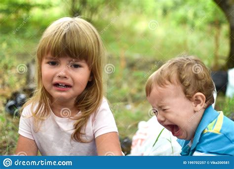 Two Little Crying Baby Girls Outdoor Upset Girls Sisters Stock Image