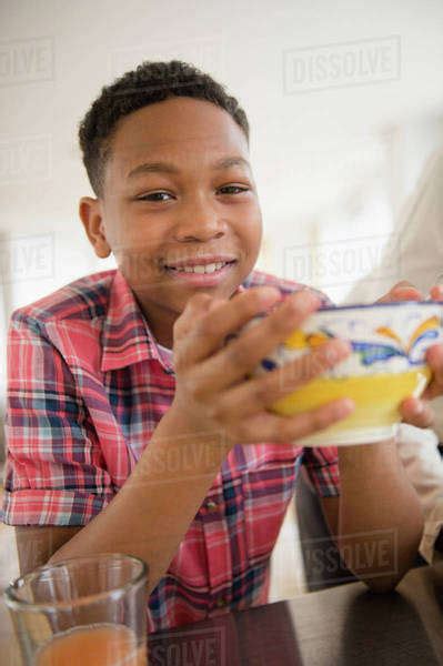 Black Boy Eating Breakfast In Kitchen Stock Photo Dissolve