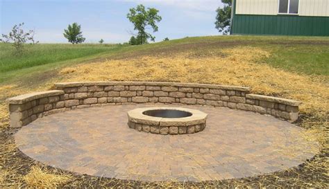 To build a backyard fire pit with bricks, start by digging a circular hole that's 4 feet in diameter and 12 inches deep. Fire Pits Landscape Company in Western Twin Cities Metro Area Minnesota