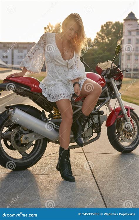 Blonde Biker In White Dress Posing On Motorcycle Outdoors Stock Image Image Of Biker Outside