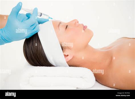 Woman Receiving Botox Injection On Her Forehead Stock Photo Alamy