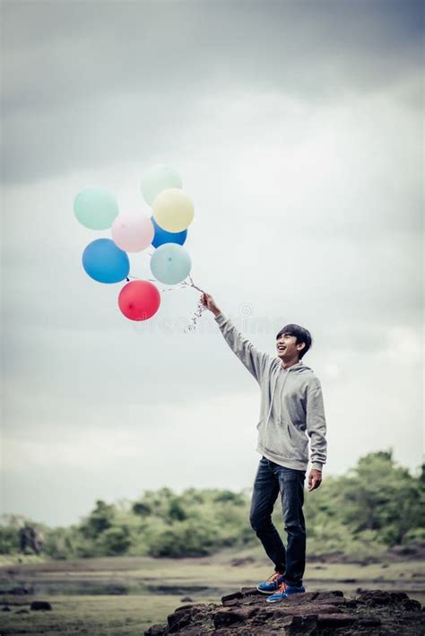 Young Man Holding Bunch Of Colorful Balloons Stock Image Image Of