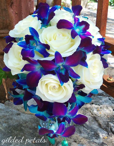 One white fringed tulip (the blurry white flower on the right). Gilded Petals, Blue Orchid, White Rose Cascade Bouquet ...