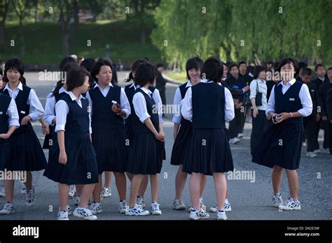 A Group Of Japanese High School Girls In Uniform On A Field Trip To