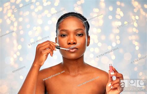African American Woman Applying Lip Gloss Stock Photo Picture And Low