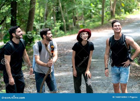 Group Of Friends Hiking Together Talk Happy While Hiking Up The
