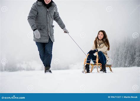 Man Pulling Woman On Sleigh In Winter Forest Stock Image Image Of