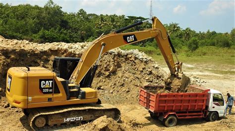 cat gc excavator loading dirt  dump trucks youtube