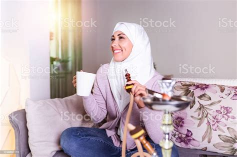 Muslim Woman Smoking Shisha At Home And Drinking Coffee Or Tea Muslim