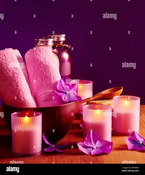 Photo Of Spa Still Life On Purple Background Picture Of Pink Bath Candles And Bottles With