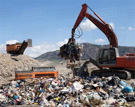 Machinery Grabbing Waste In Landfill Stock Photo Dissolve