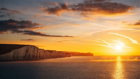 2560x1440 Beautiful Ocean Sunset The Seven Sisters Cliffs 4k 1440p