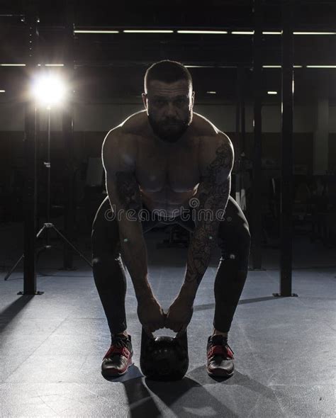 attractive muscular bodybuilder doing deadlifts in modern gym f stock image image of squat