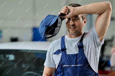 Premium Photo Mid Adult Car Mechanic Feeling Exhausted After Work In