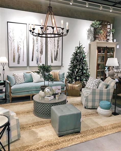 A Living Room Filled With Lots Of Furniture And Christmas Trees In
