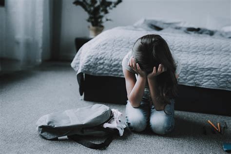 Sad Girl Sitting On Floor In Bedroom And Crying Stock Photo Download