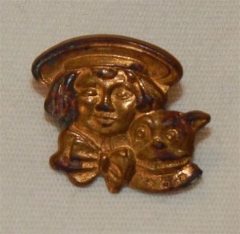 A Gold Brooch With A Woman Holding A Cat