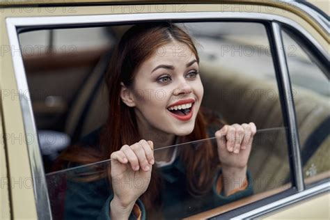 Caucasian Woman Smiling In Back Seat Of Car Photo Tetra Images