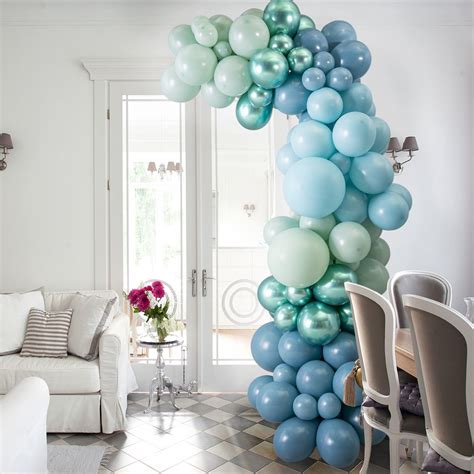 The Balloon Arch Is Decorated With Pastel Blue Green And White