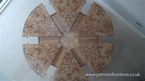 Leaves go around the outside of these tables and keep the shape round. Expanding circular dining table in burr poplar and elm