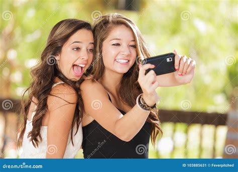 Playful Mixed Race Teen Girlfriends Using Their Smart Cell Pho Stock Image Image Of Computer