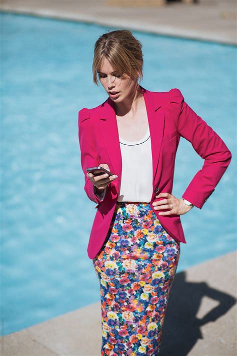 Portrait Of A Blond Girl In A Pink Suit By The Pool In The Summer By A