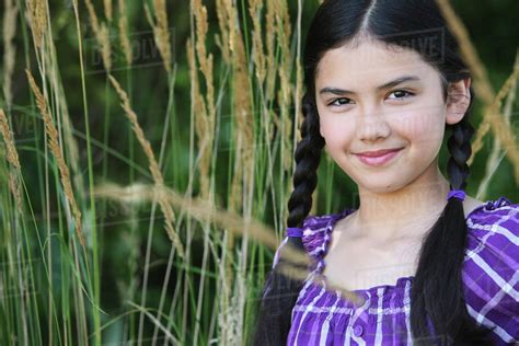 portrait of a girl with long braids standing in wheat troutdale oregon united states of