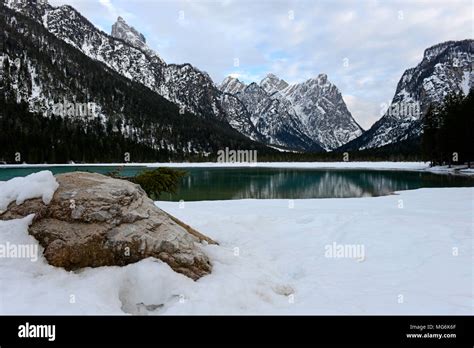 Partly Frozen Lake Near Dobbiaco In The Dolomites Italy Stock Photo
