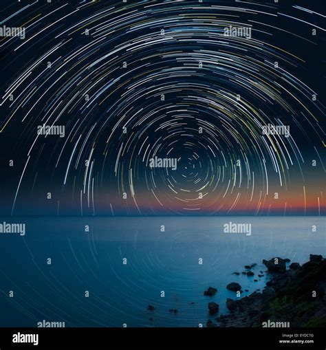 A Star Trail Over A Rocky Coast And Sea Scape Stock Photo Alamy