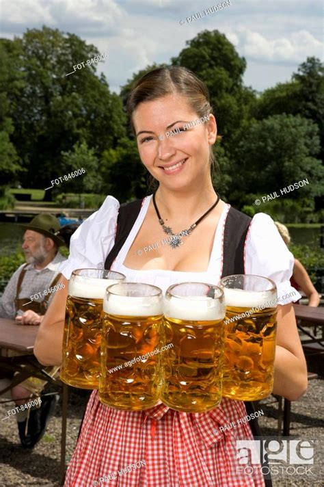 A Traditionally Clothed German Woman Serving Beer In A Beer Garden