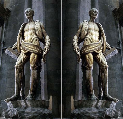 Saint bartholomew shot from below, focus on face of the statue at the west front of lichfield cathedral. St Bartholomew Statue | Religious Sculpture