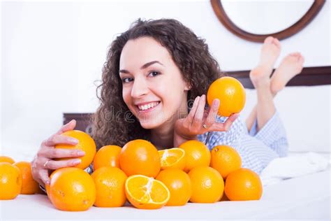 Positive Girl Eating Oranges In Bed Stock Photo Image Of European